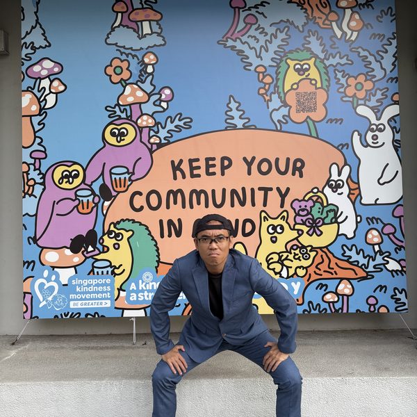 Kao posing in front of a Singapore Kindness Movement mural